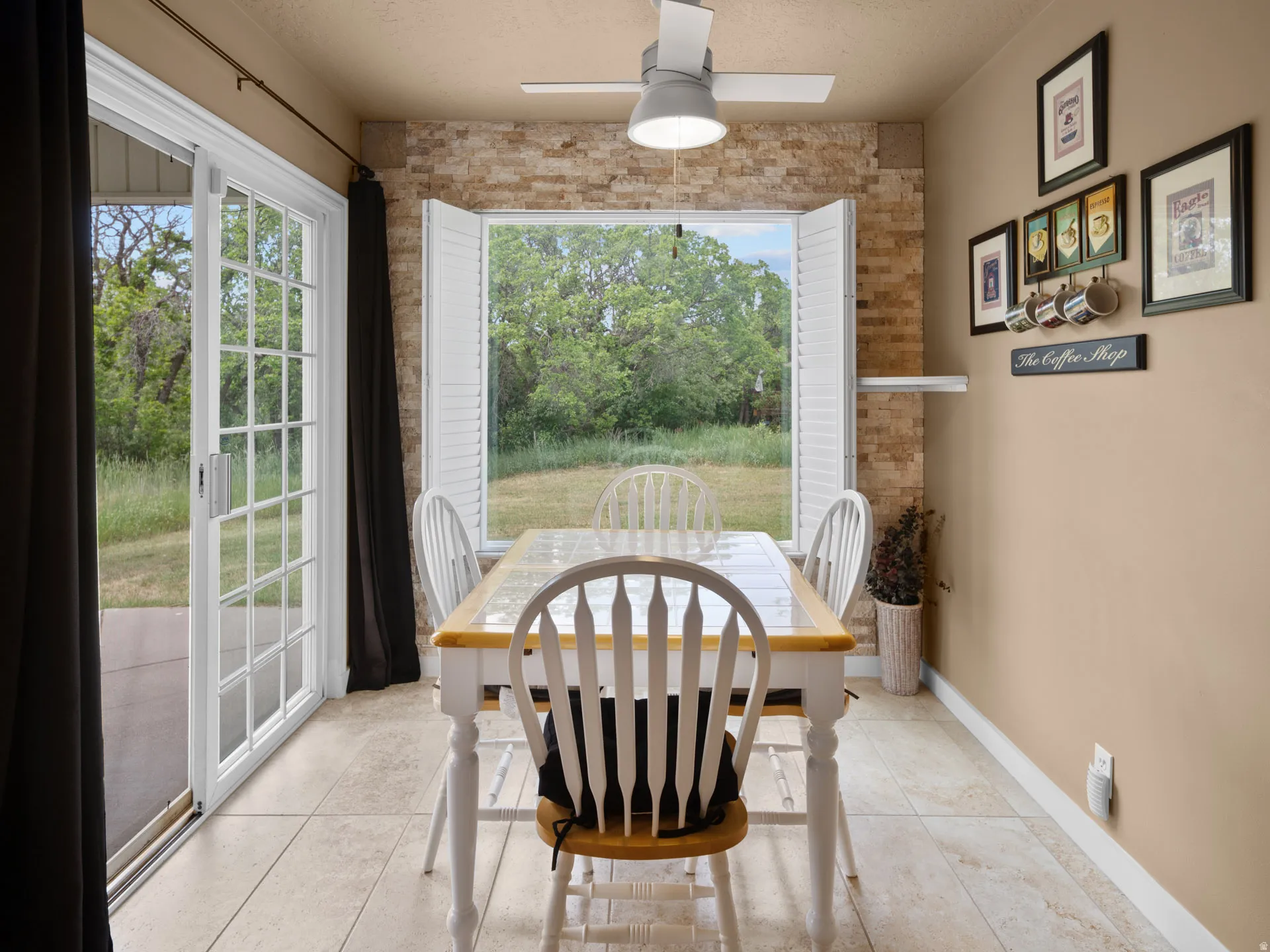 Dining area with tile flooring and a ceiling fan light fixture