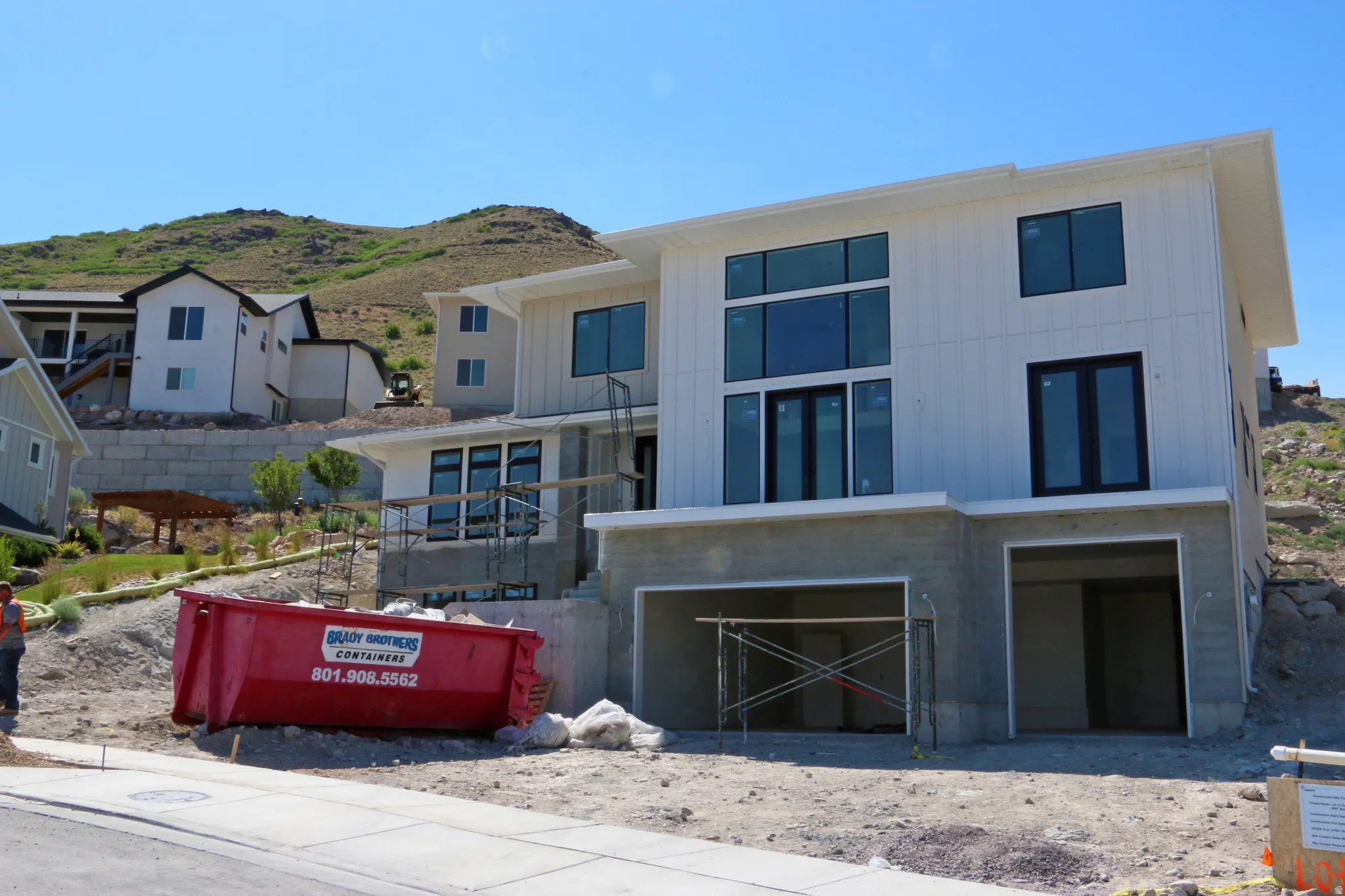 Modern architectural exterior with vertical white siding and extensive fenestration