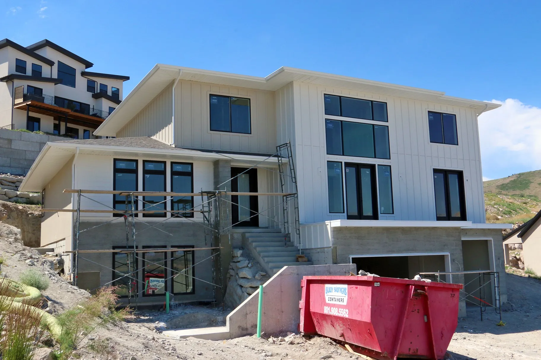 Multi-level contemporary residence featuring a white vertical board-and-batten facade