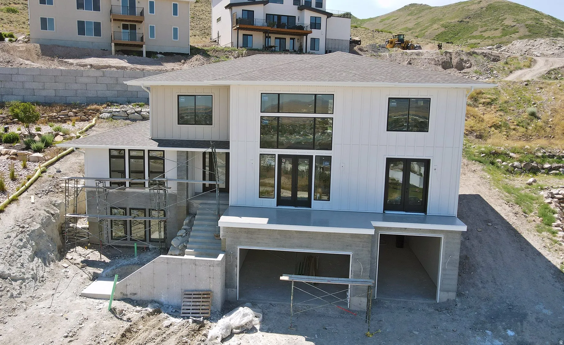 Modern white siding exterior with a multi-level design
