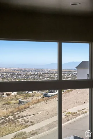 Expansive window offering a broad landscape with distant mountains