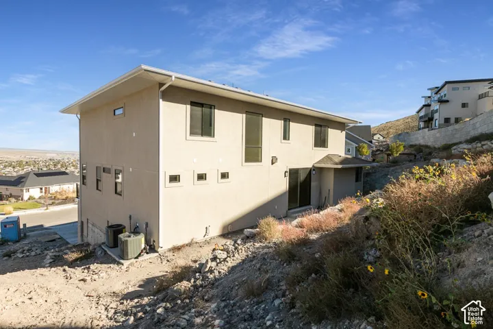 Modern stucco exterior with multiple windows and a sliding glass door