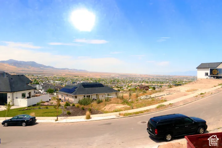 Expansive neighborhood setting featuring distant mountain ranges and a widespread community below