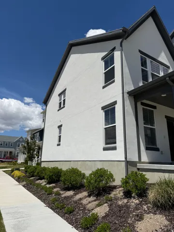 White stucco exterior featuring dark trim accents