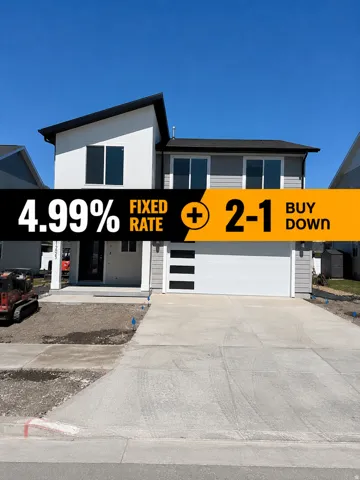 Contemporary two-story exterior with a contrasting white and gray facade, dark framed windows, an integrated garage with modern horizontal panels, and a concrete driveway