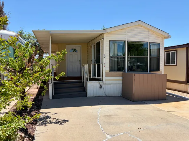 Light-toned exterior with a covered porch entry