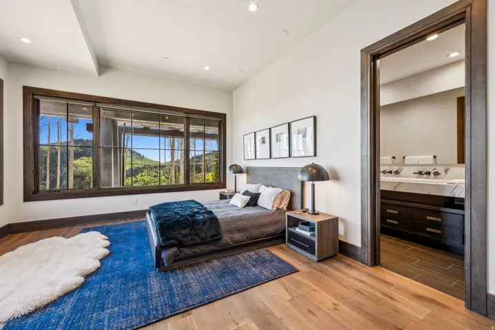 Expansive window wall with dark wood trim, offering a broad scenic backdrop