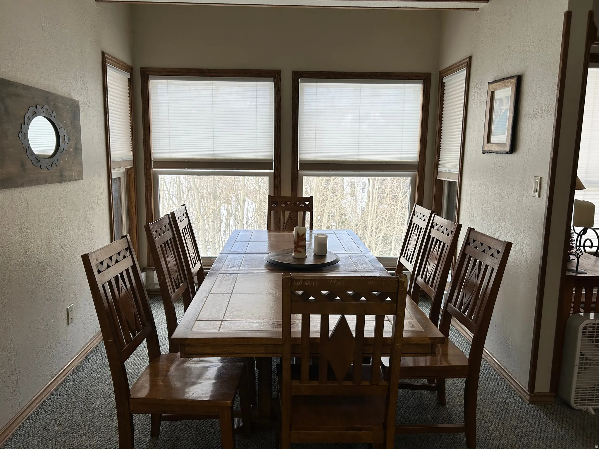 Dining area with a built-in table featuring a tiled surface and wood trim