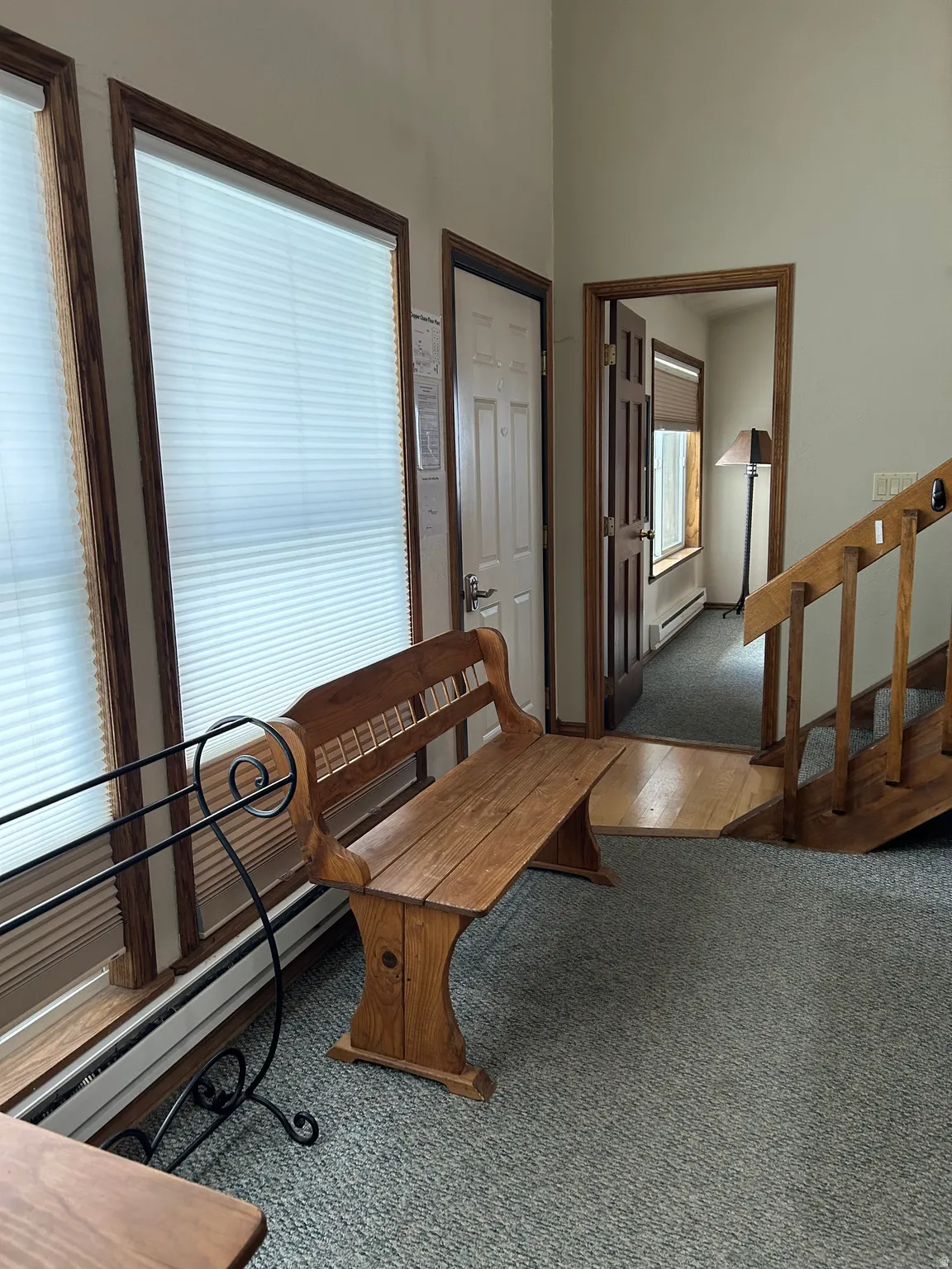 Entry area featuring light gray wall paint and matching carpet flooring