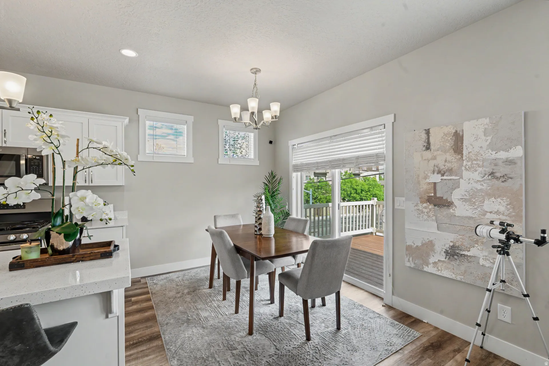 Dining area featuring a contemporary chandelier and wood-finish flooring