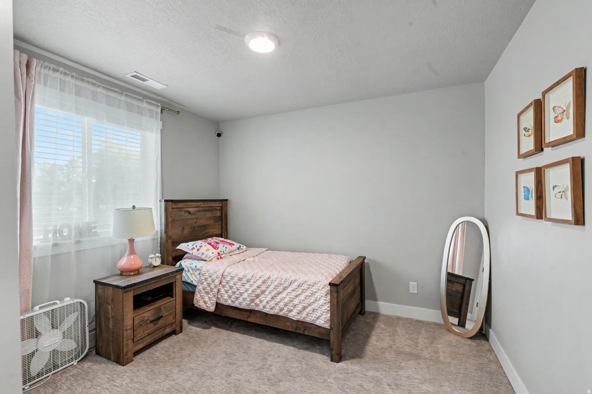 Bedroom featuring a large window with white blinds, neutral wall paint, and recessed lighting