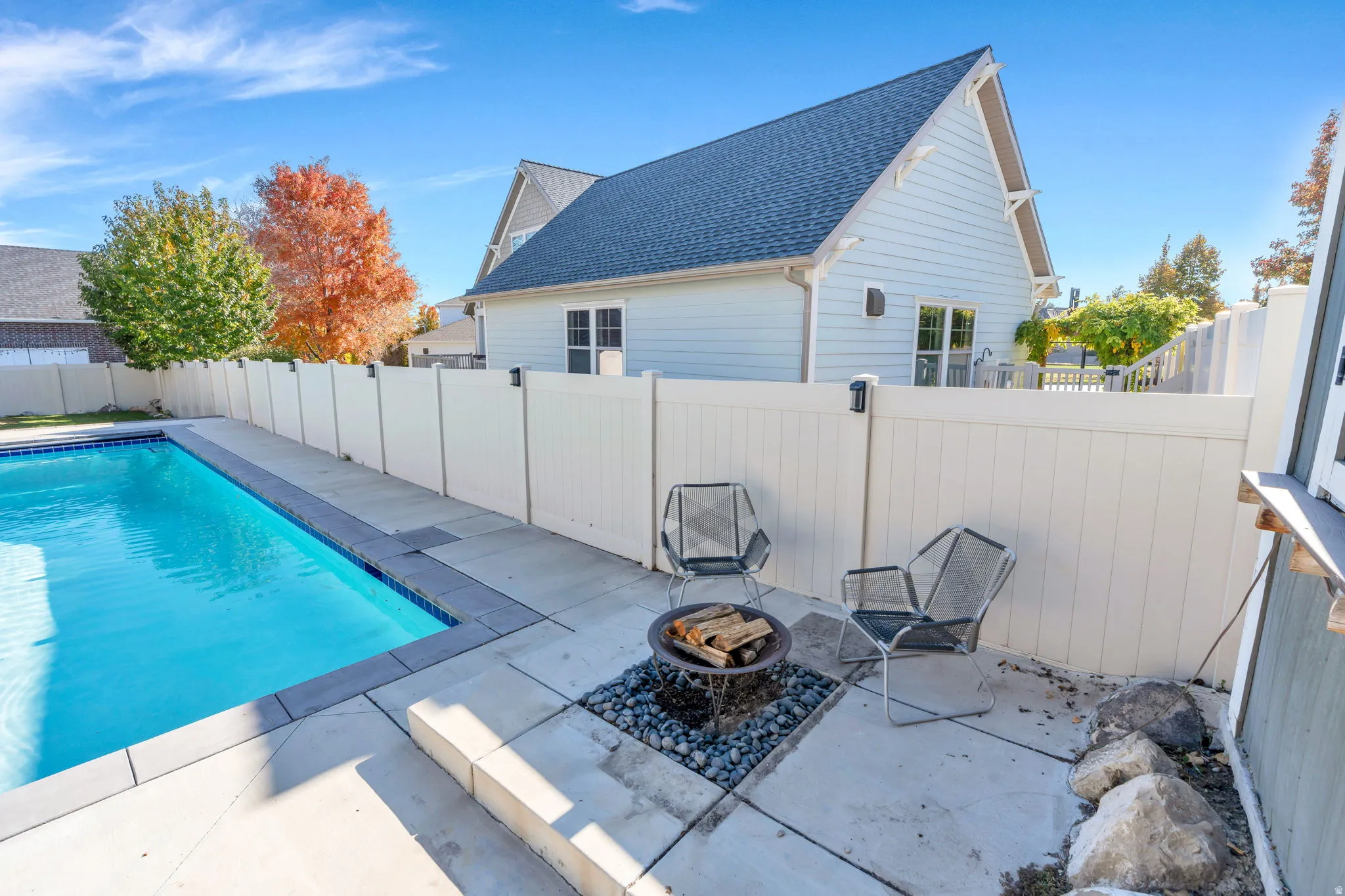 View of pool featuring an outdoor fire pit