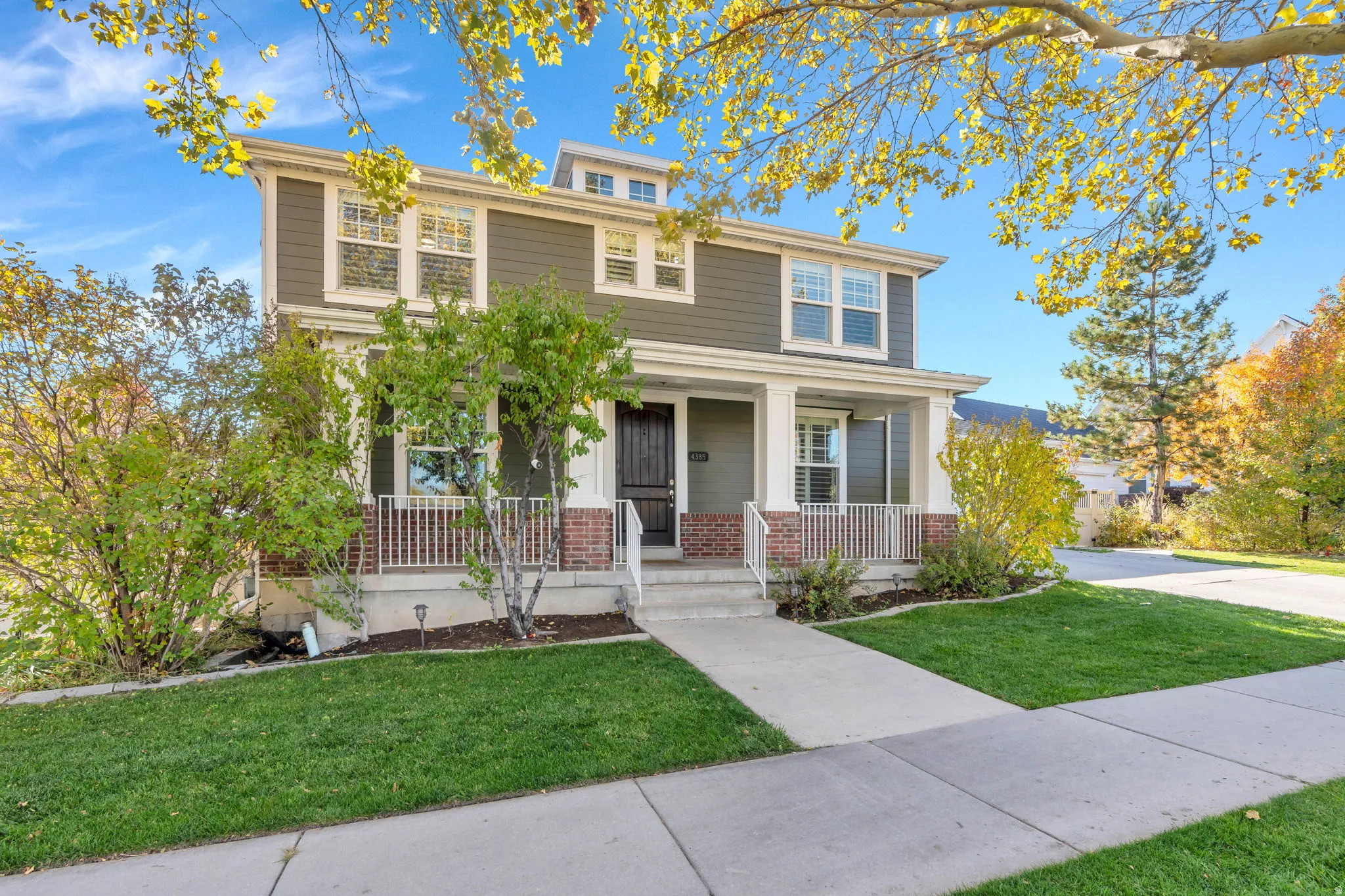 Traditional style home featuring a covered porch, and front yard