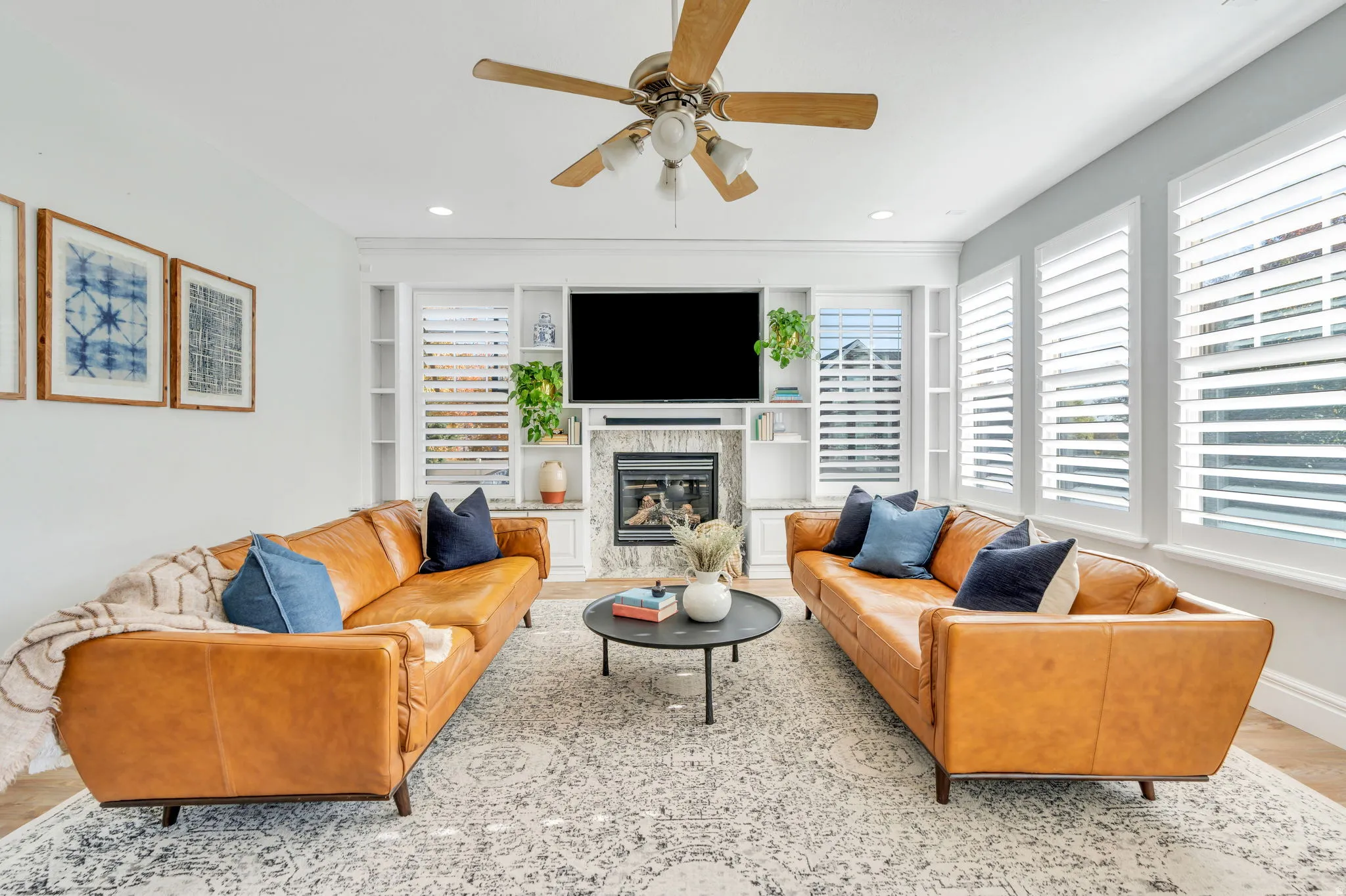 Family room with ceiling fan, built in shelves, healthy amount of natural light, and recessed lighting