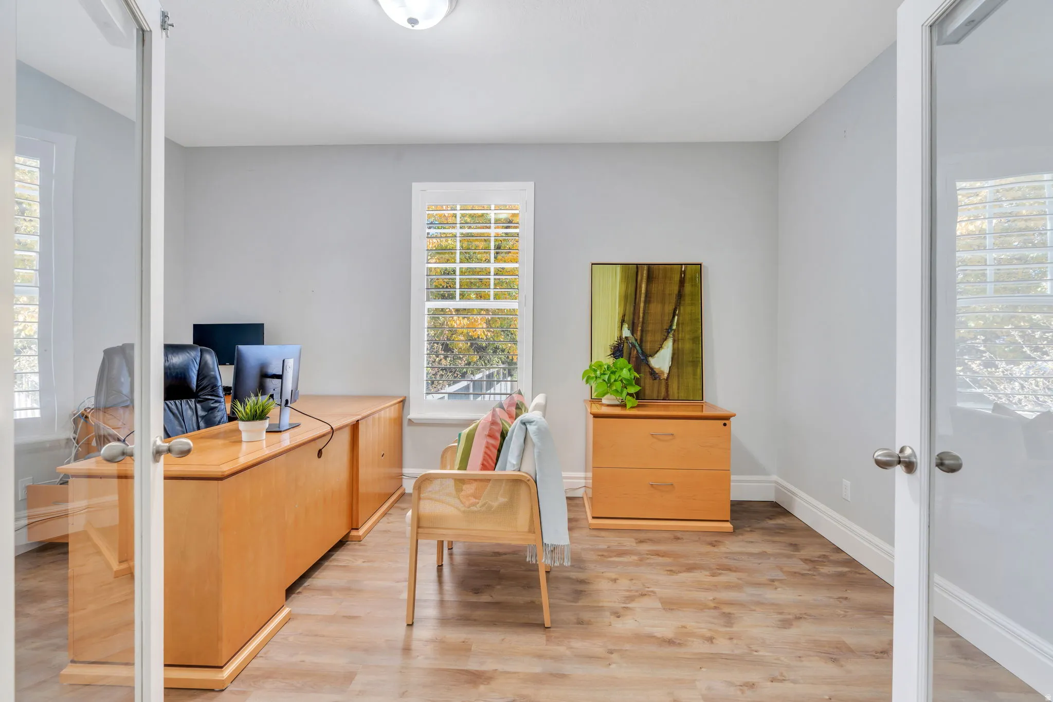 Home office featuring light LVP floors and French doors