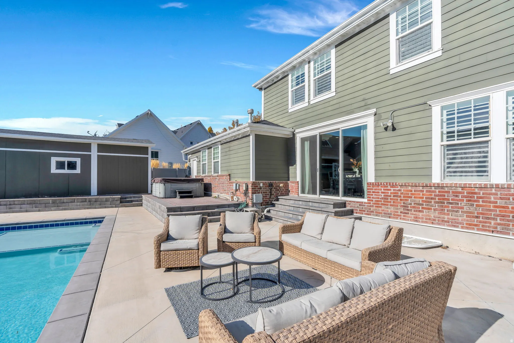 View of patio featuring outdoor seating and a hot tub