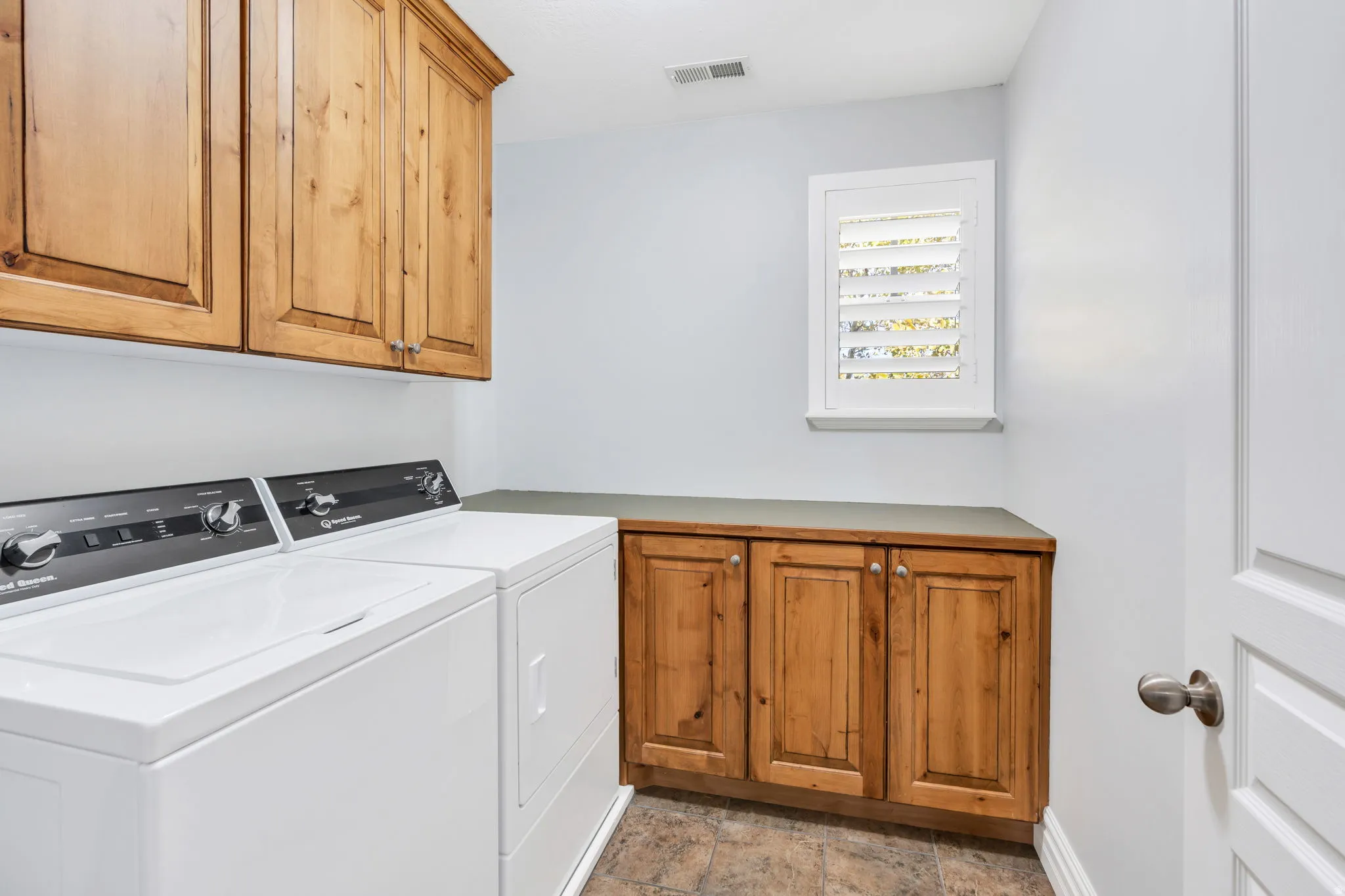 Laundry room featuring cabinet space, separate washer and dryer
