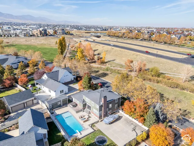 Aerial view of subject home with pool and the surrounding residential area