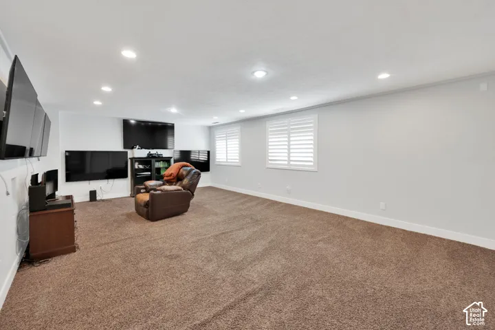 Expansive room featuring recessed lighting and carpet flooring