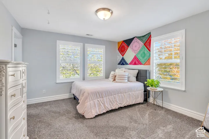 Bedroom with carpeted floors, en-suite attached