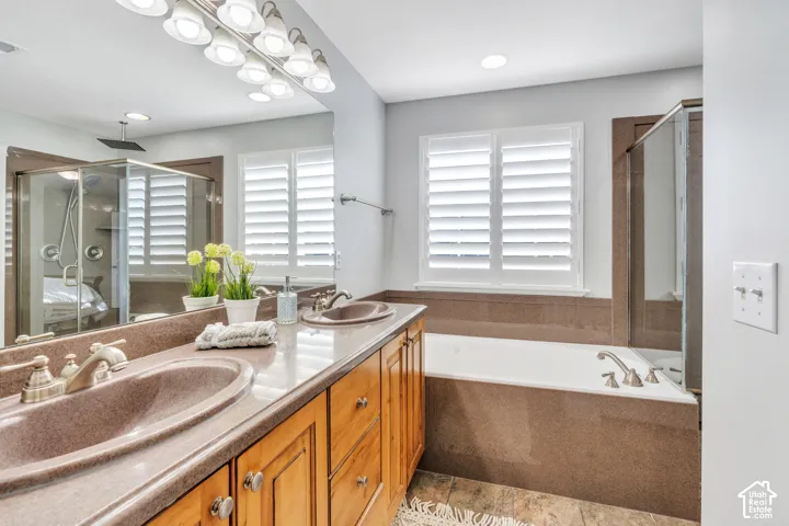 En suite bathroom with double vanity, and jetted tub