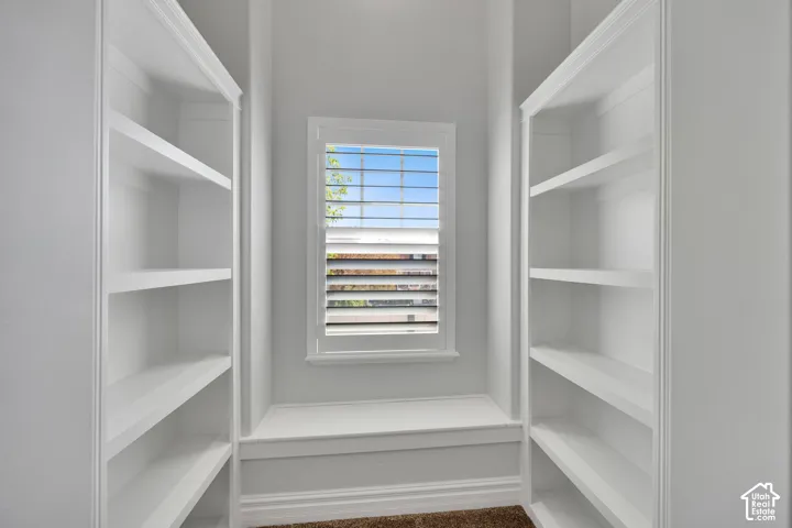 Built-in shelving and reading nook with white shutters and a built-in bench