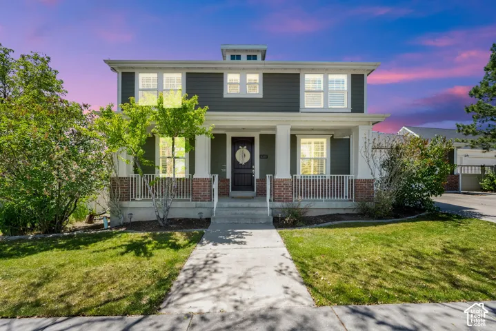Two-story residence featuring dark siding and white trim