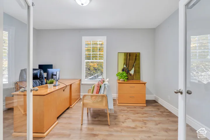 Home office featuring light LVP floors and French doors