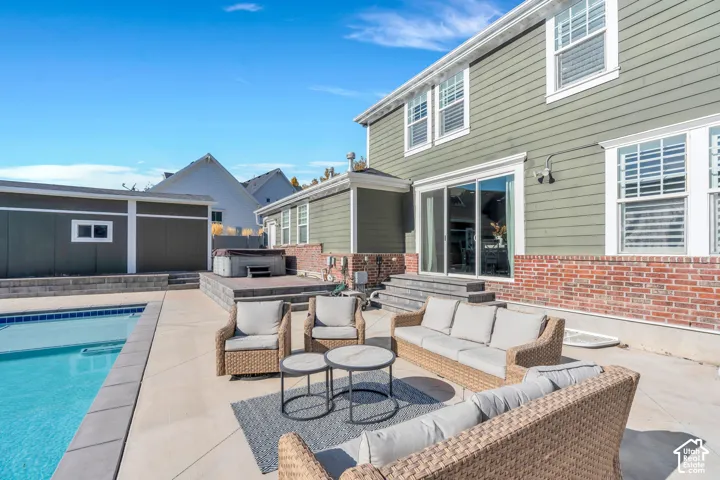 View of patio featuring outdoor seating and a hot tub