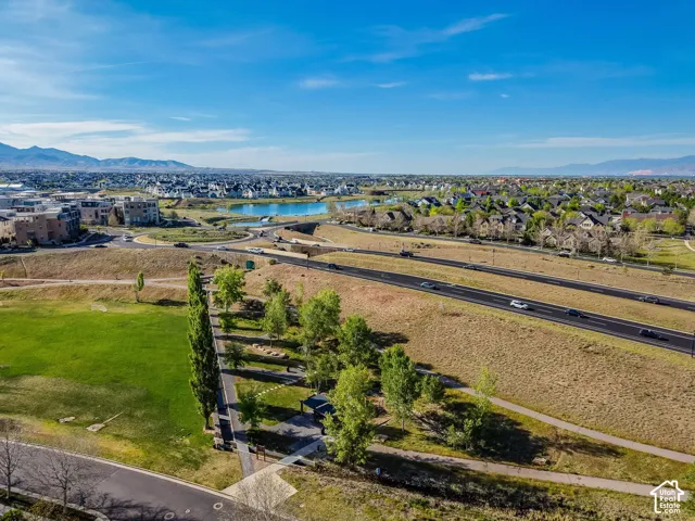 Daybreak residential development with a large green space, established roadways, and a prominent body of water