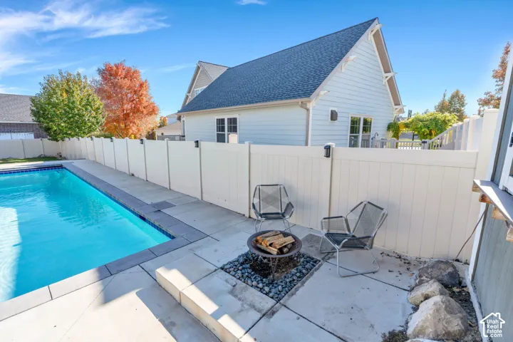 View of pool featuring an outdoor fire pit
