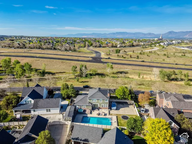 Expansive property featuring a pool, surrounding patio, and a large yard
