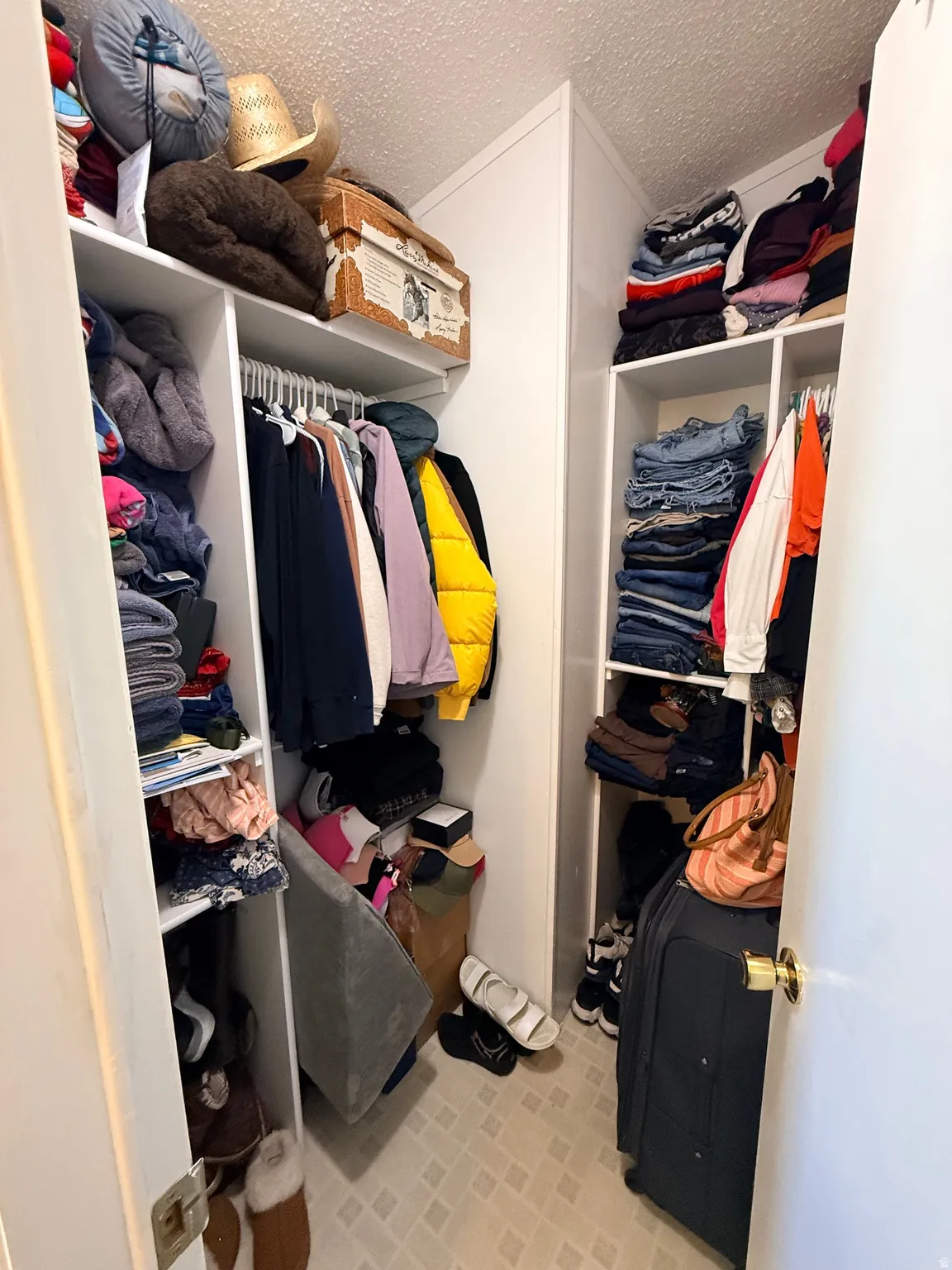 Walk-in closet featuring built-in shelving, hanging rods, and light-toned flooring