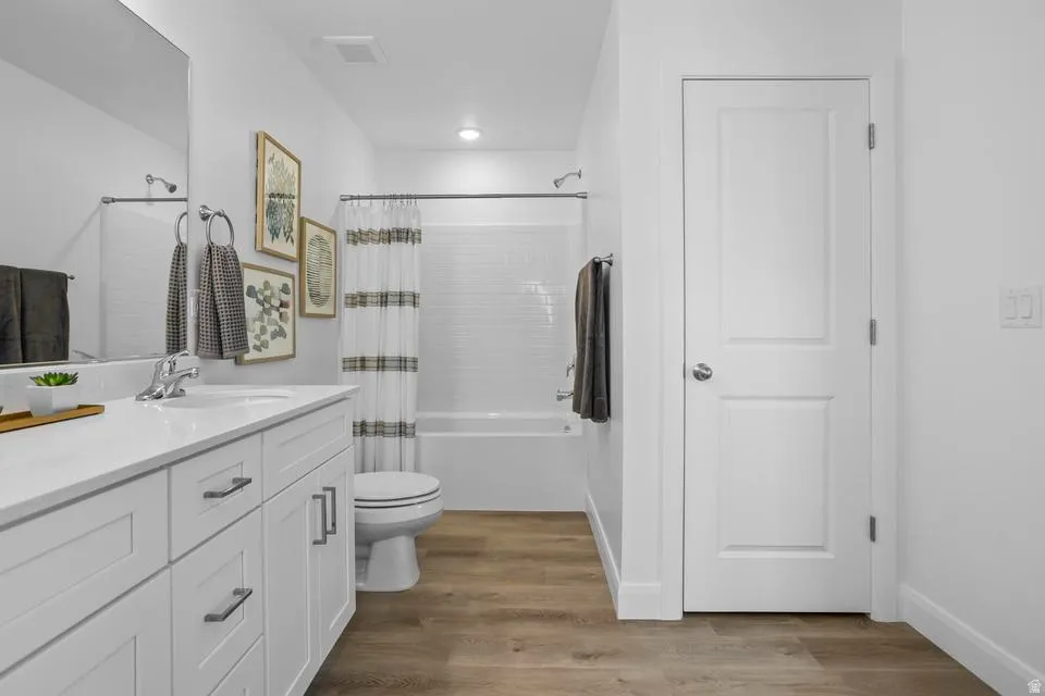 Well-appointed bathroom featuring a white vanity with a quartz countertop, an undermount sink, and chrome fixtures