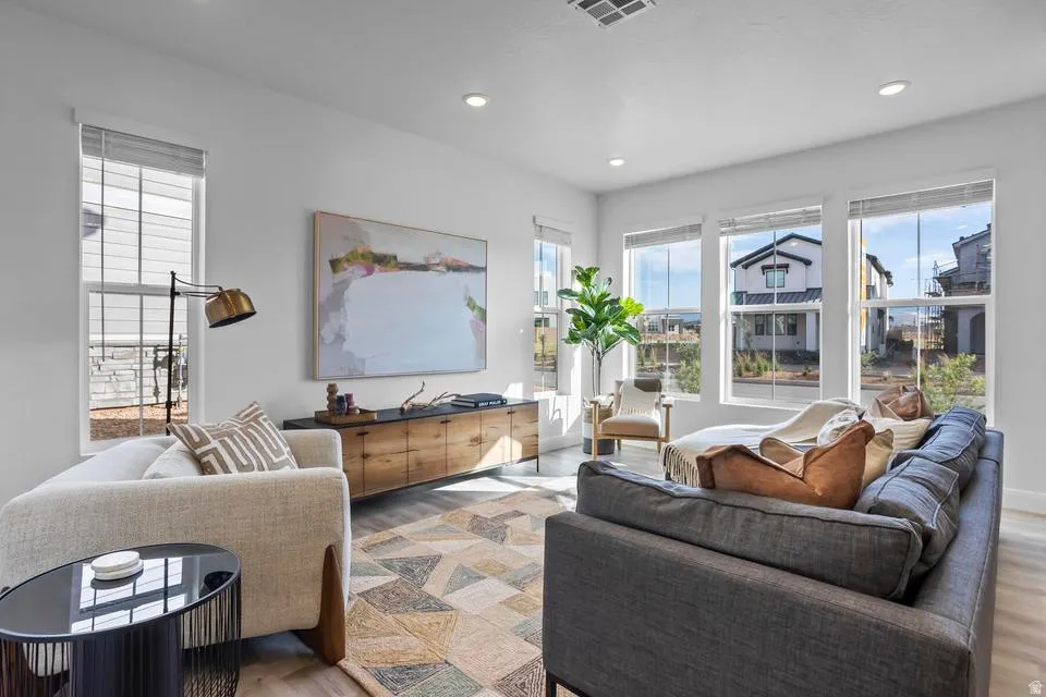 Bright living area featuring abundant natural light from multiple windows