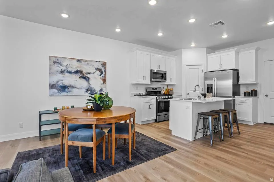 Open-concept living space with light wood-finish flooring