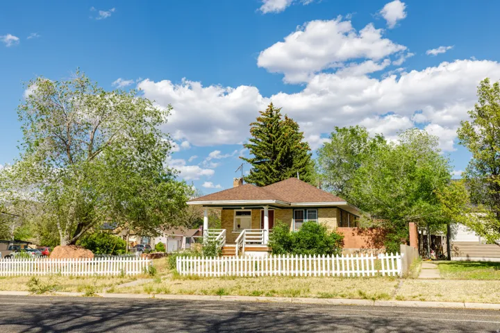 Traditional-styleStreet View / Front Exterior residence featuring a prominent front porch, brick and siding exterior, and a gabled roof
