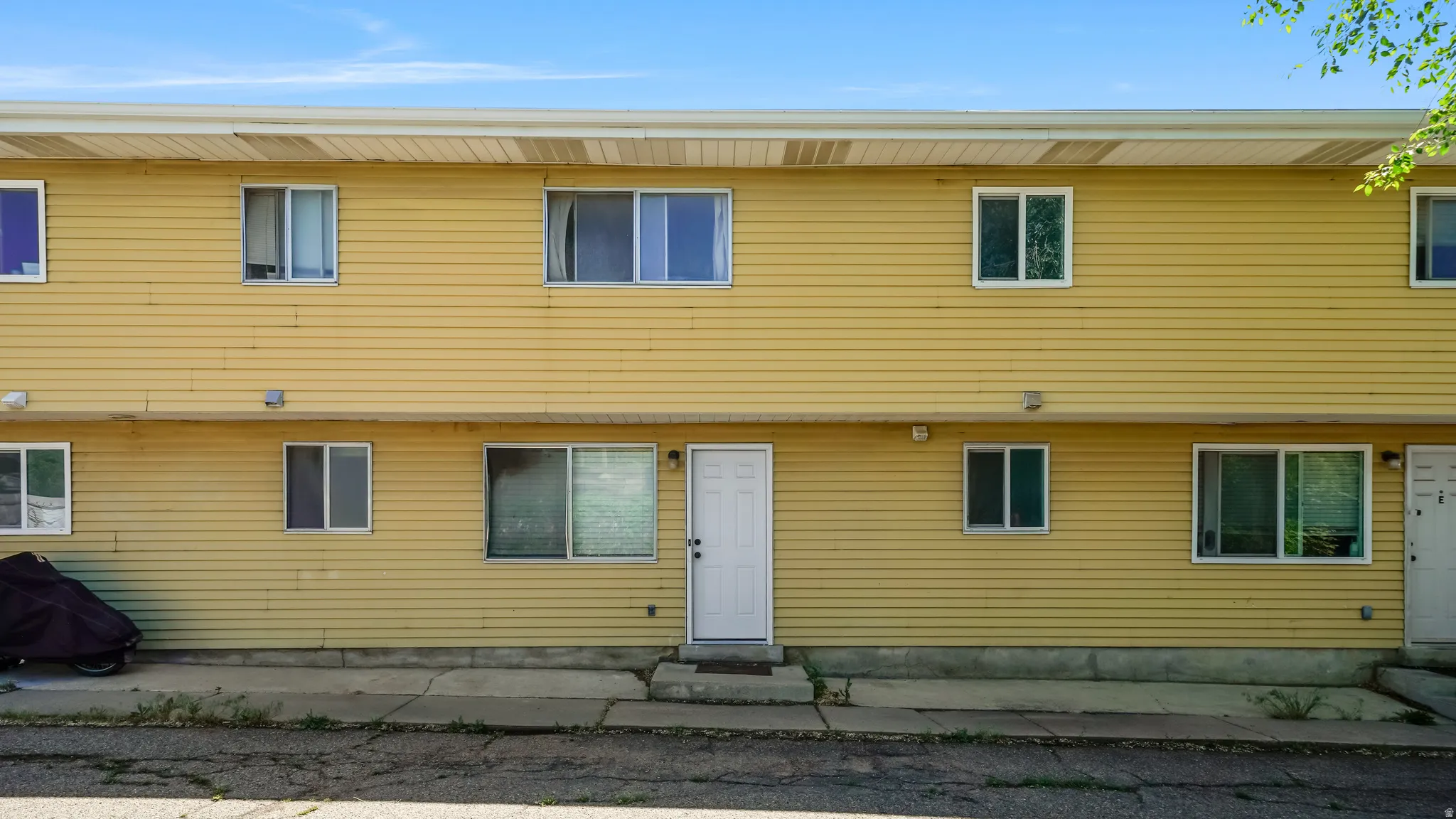 Two-story exterior featuring horizontal siding and multiple windows