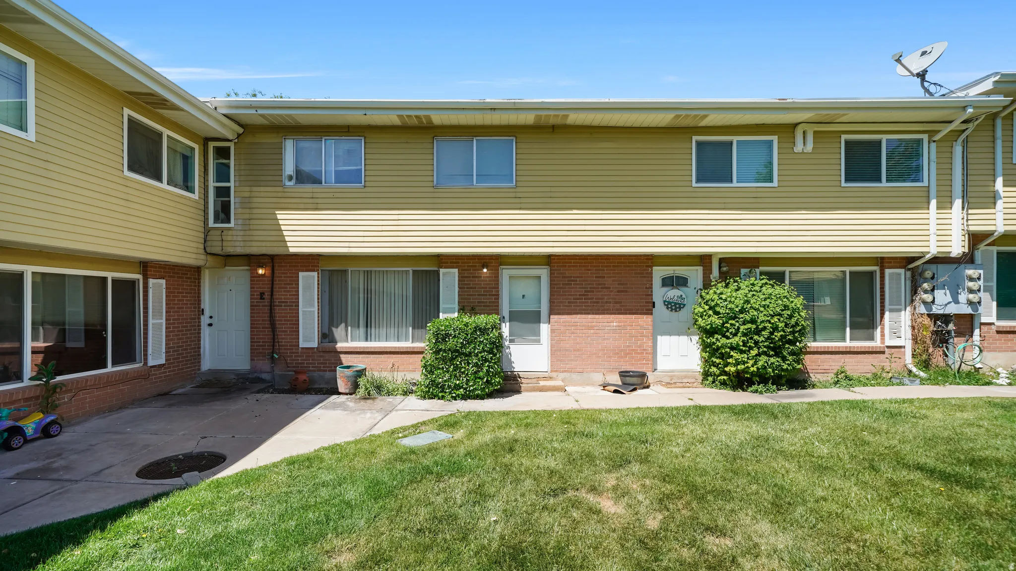 Two-story multi-unit dwelling featuring a brick and horizontal siding exterior