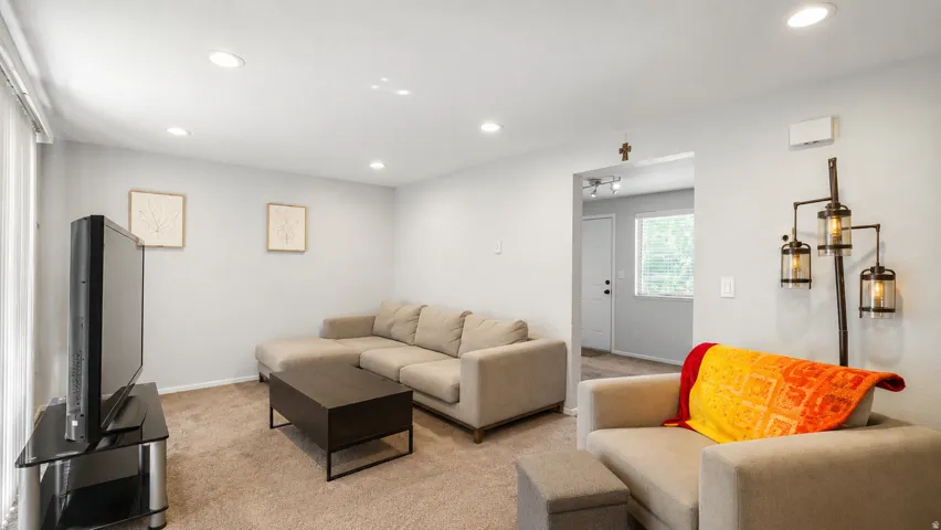Carpeted living area featuring recessed lighting, light gray walls, and baseboard trim