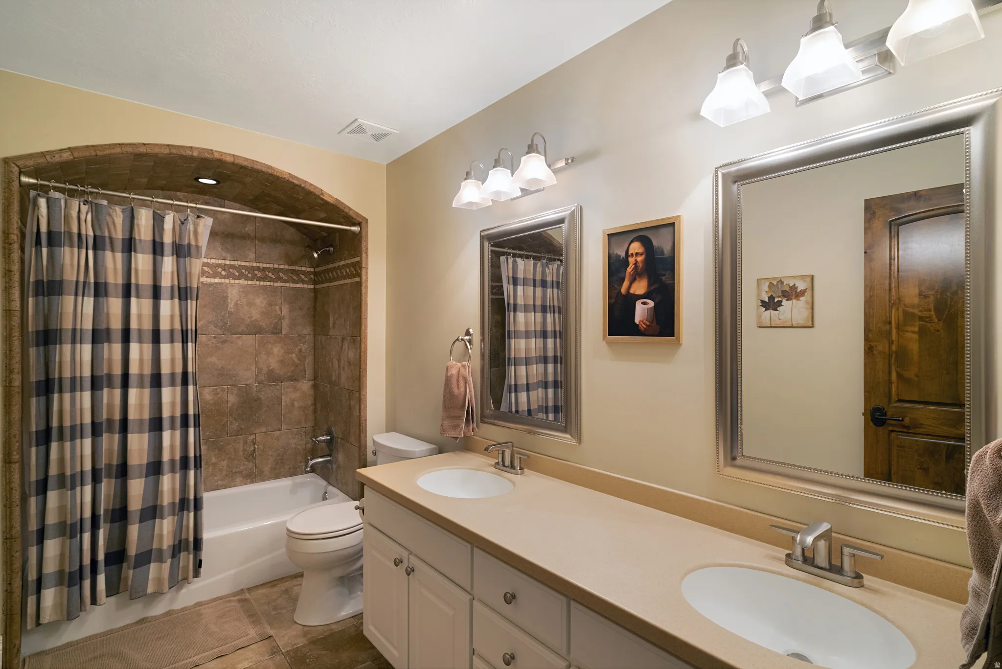 Dual vanity with integrated sinks and brushed nickel faucets, set against a neutral-toned countertop