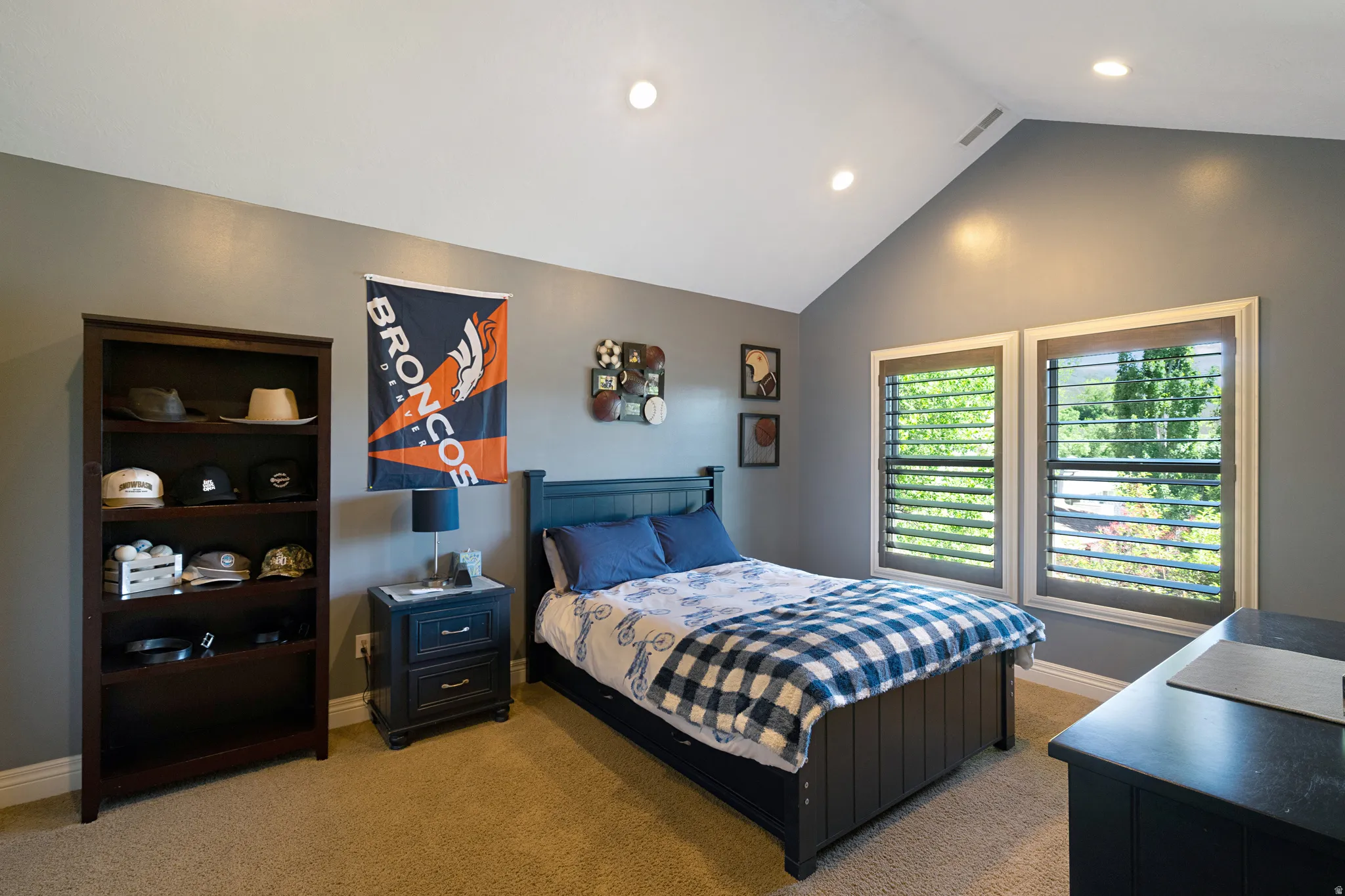 Interior room featuring a vaulted ceiling with recessed lighting