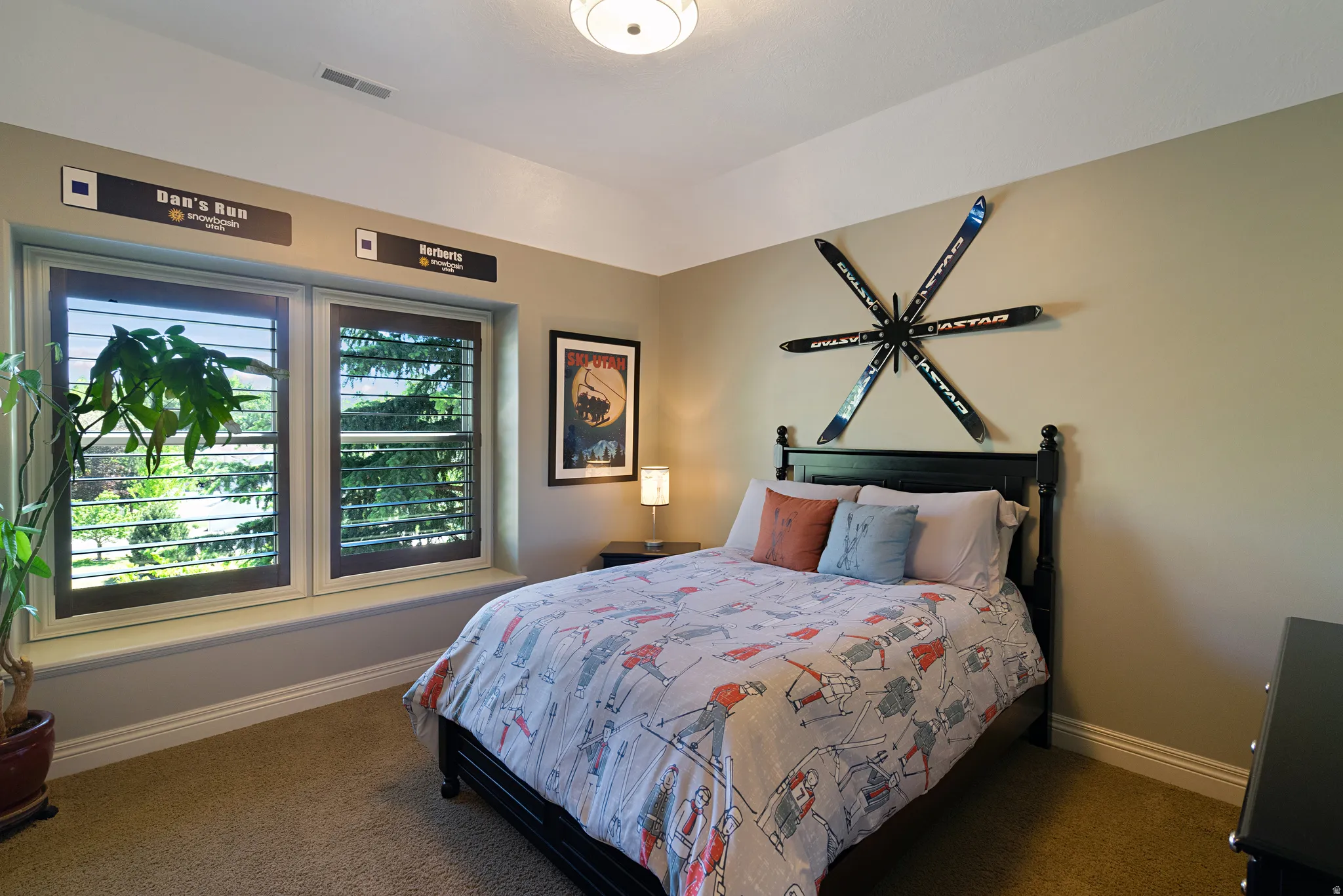 Carpeted room featuring dual windows with interior plantation shutters
