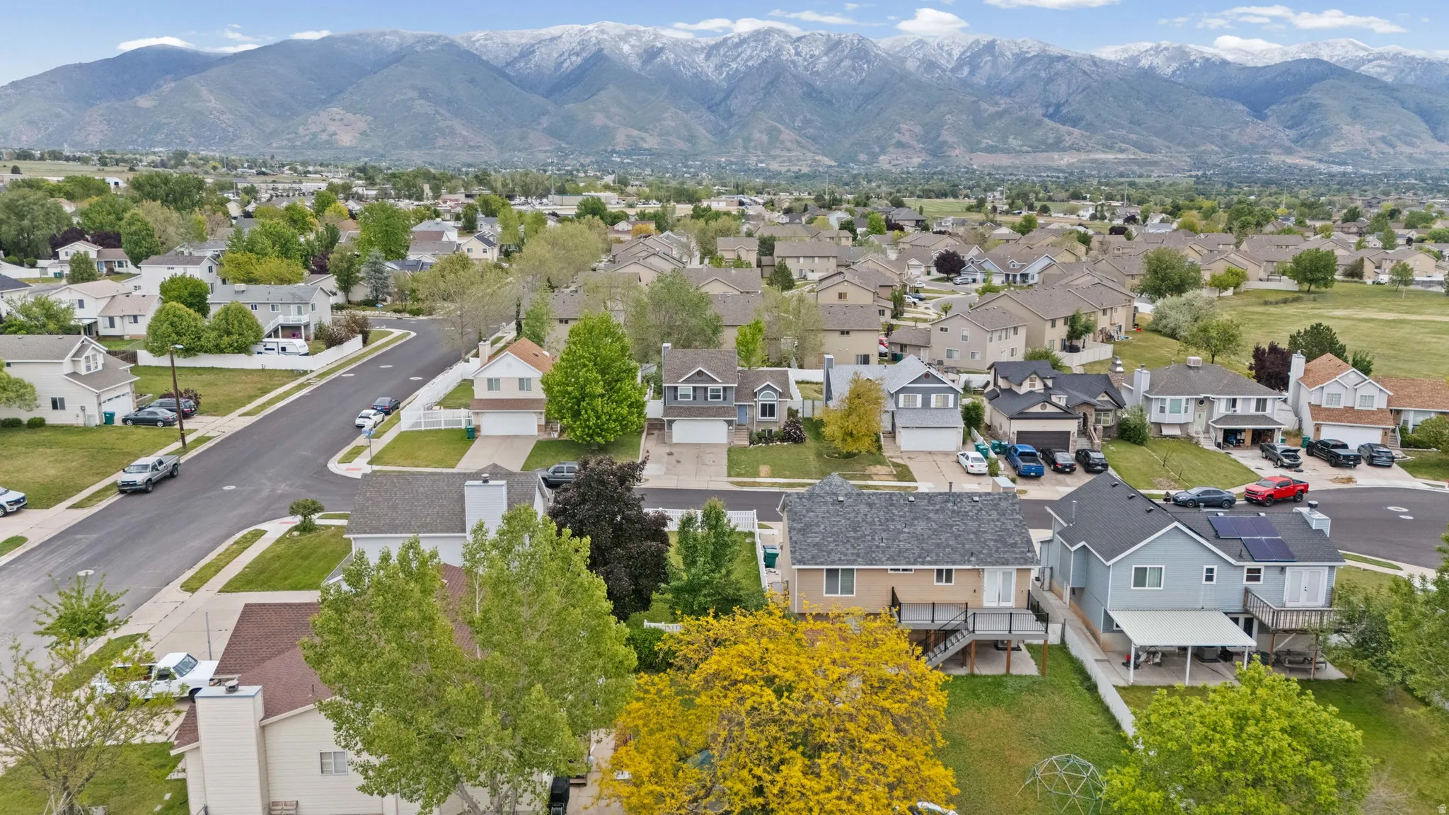 Residential neighborhood with a backdrop of snow-capped mountains