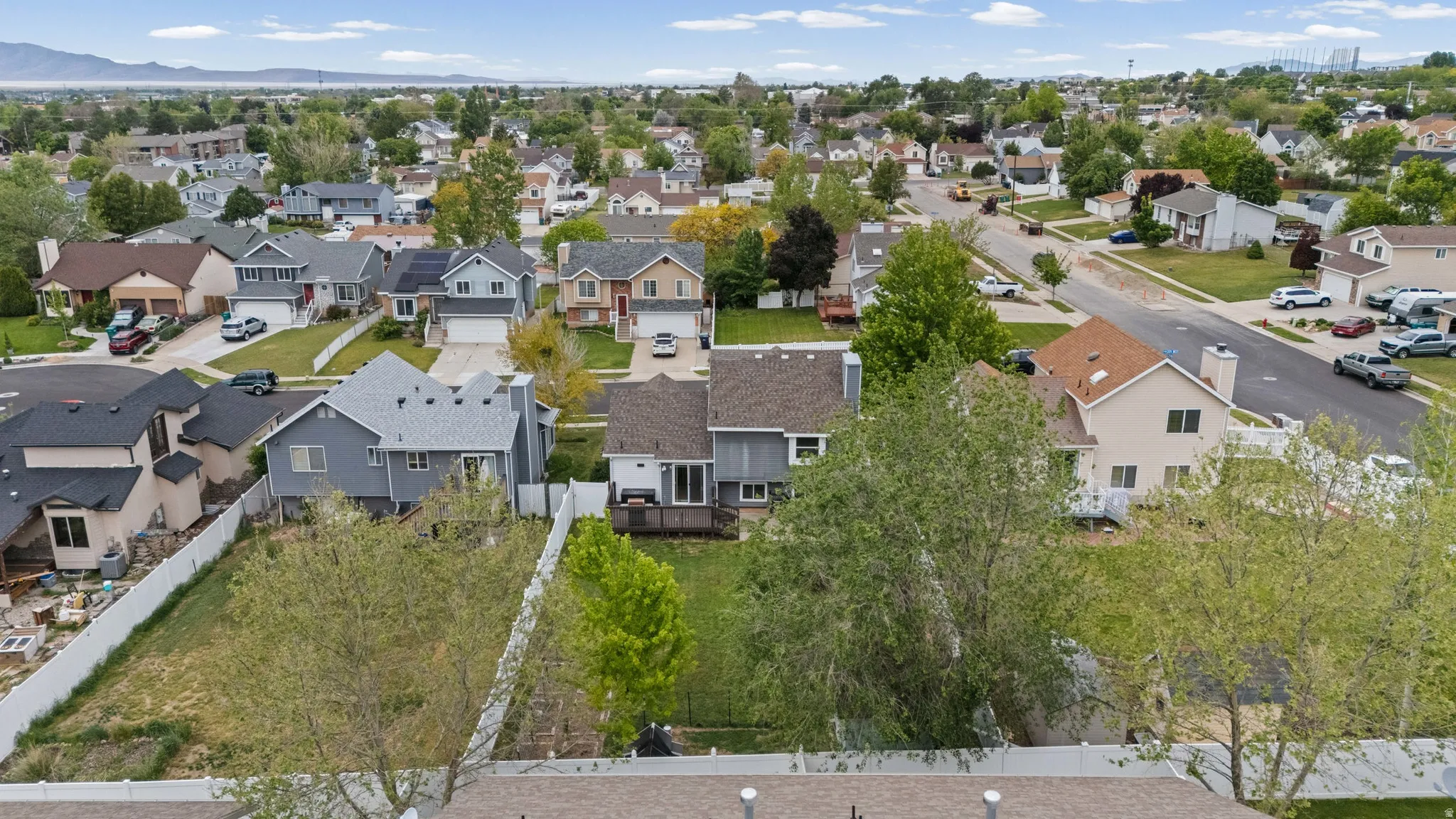 Aerial perspective showcasing a residential neighborhood with a distant mountain range backdrop