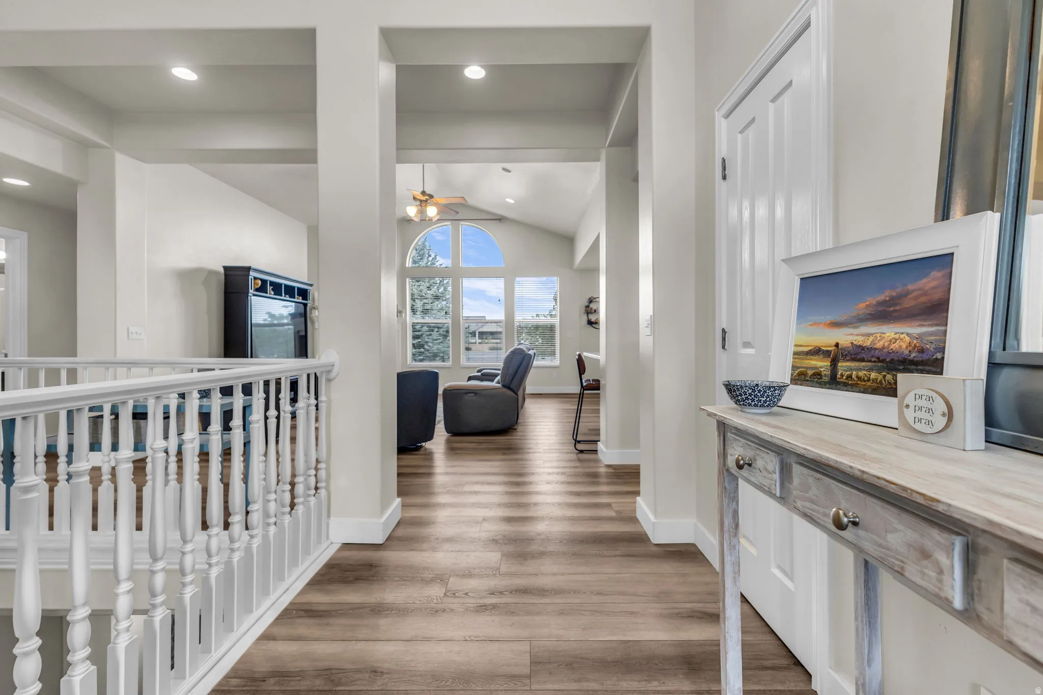 Hallway featuring wood-finish flooring and white baseboards