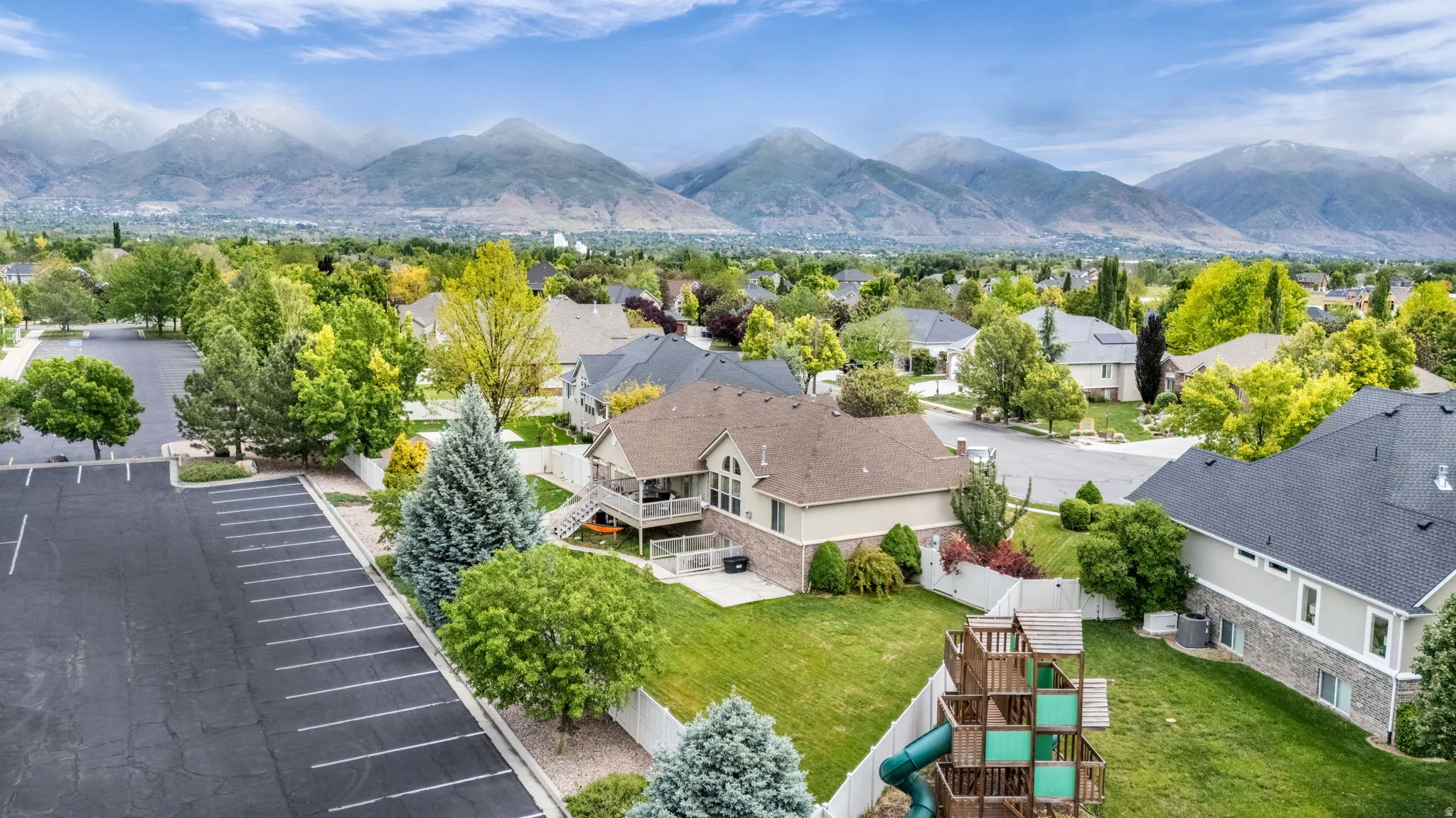 Expansive suburban landscape featuring residential properties set against a backdrop of distant mountains