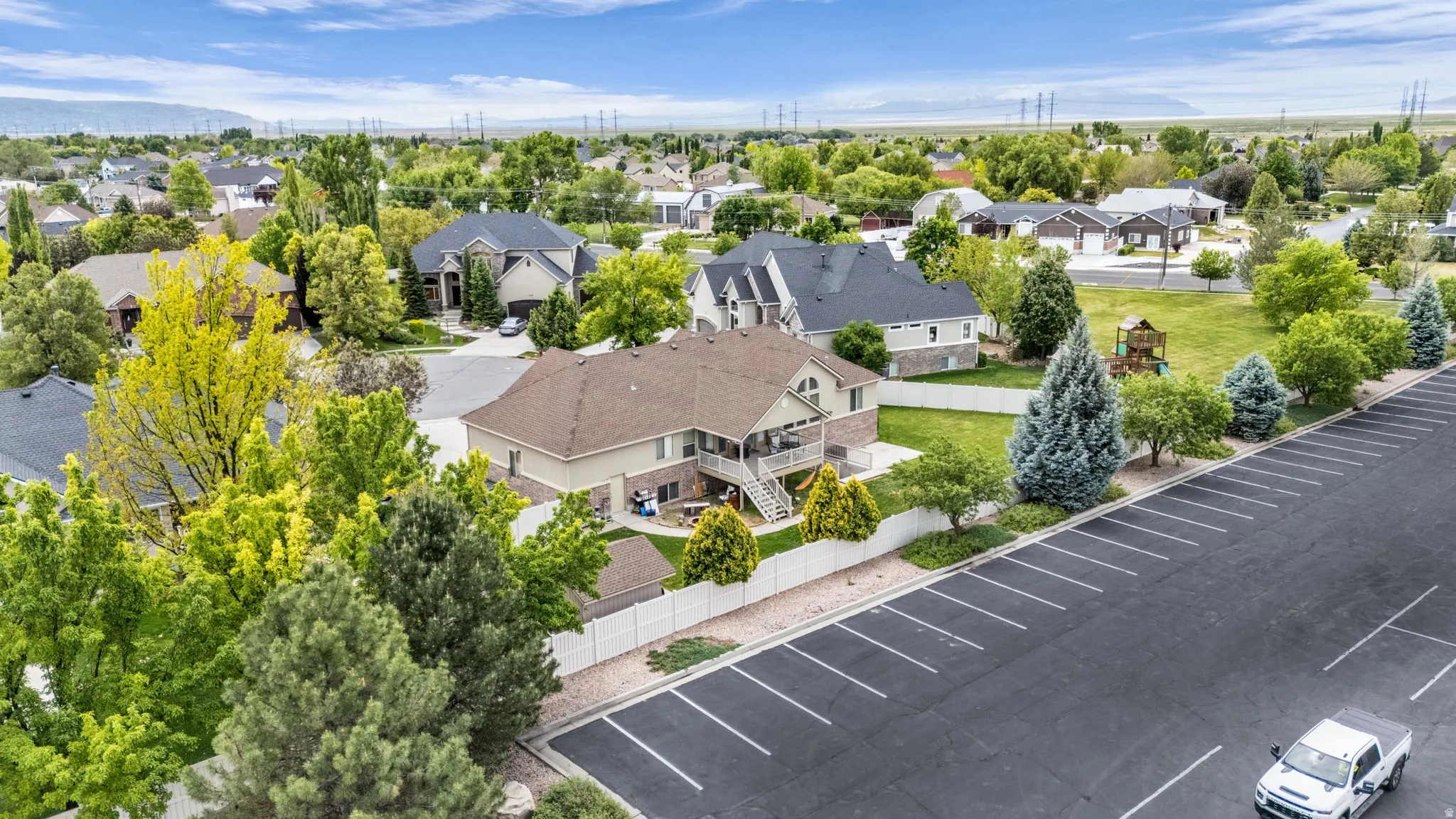 Spacious lot with a two-story residence, featuring a covered deck and lower patio