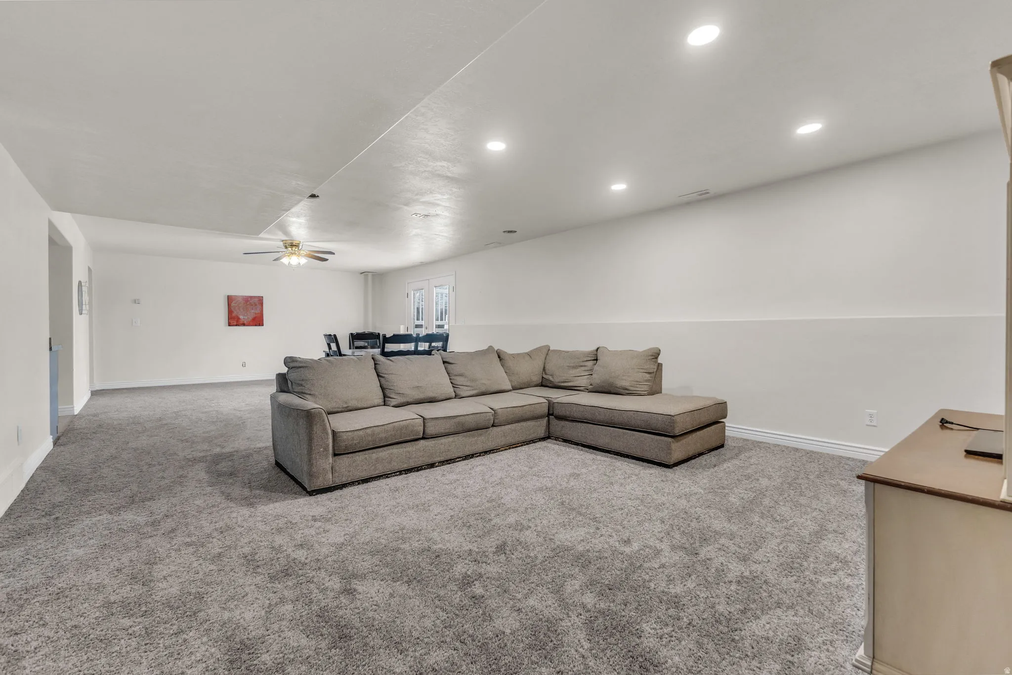 Spacious interior featuring neutral carpeting and white walls