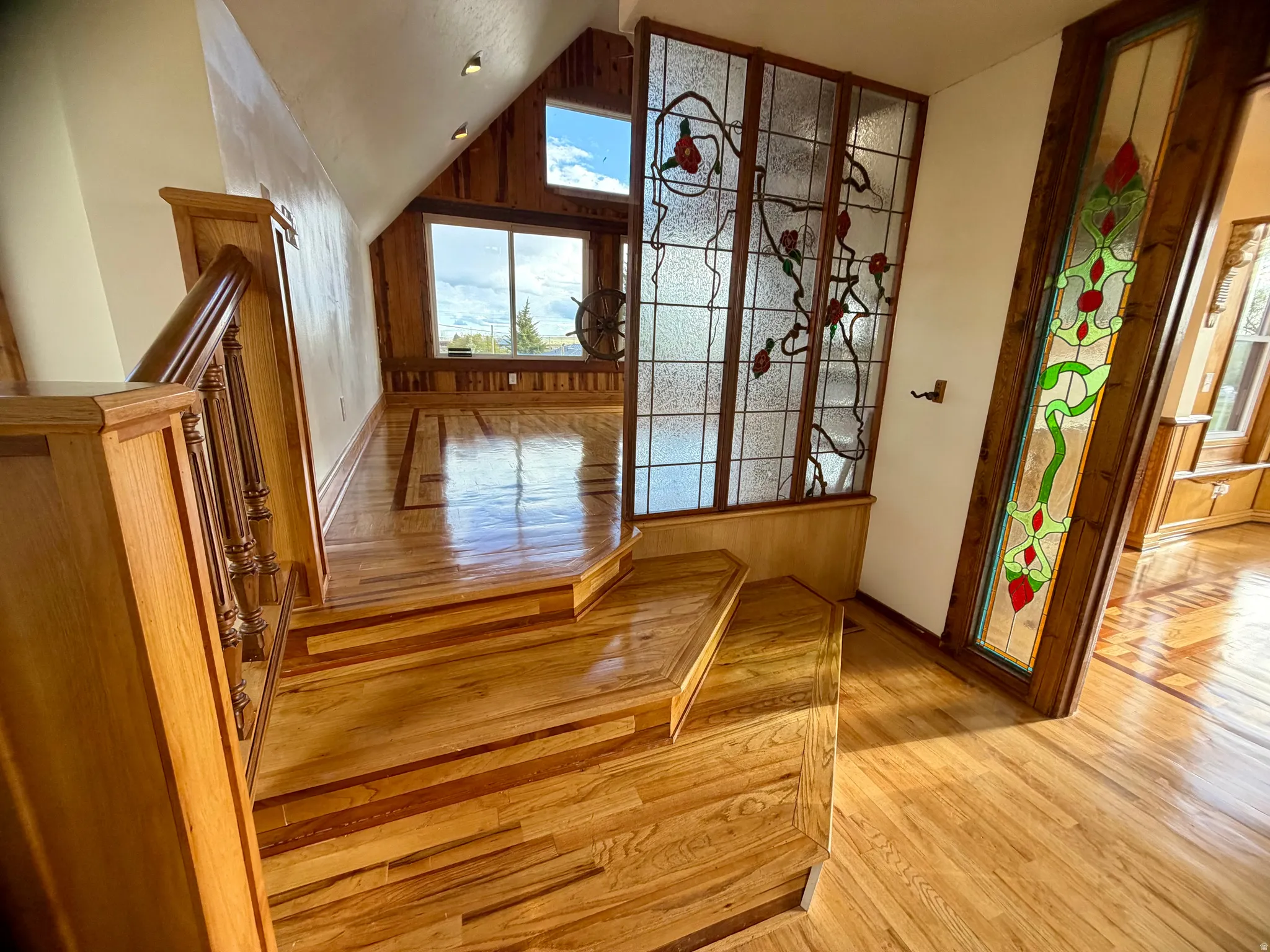 Hardwood staircase featuring carved balusters and newel posts